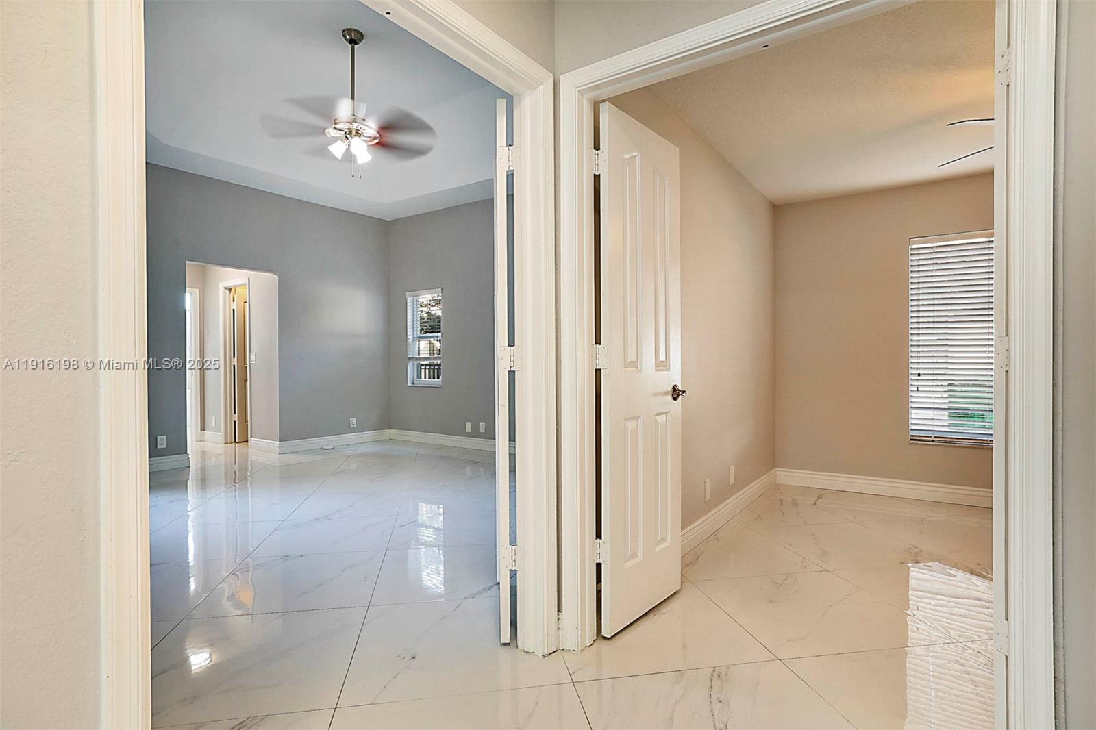 10133 Northwest 48th Drive Coral Springs, FL 33076 - Photo 37 of 49 a view of a hallway with chandelier and glass door