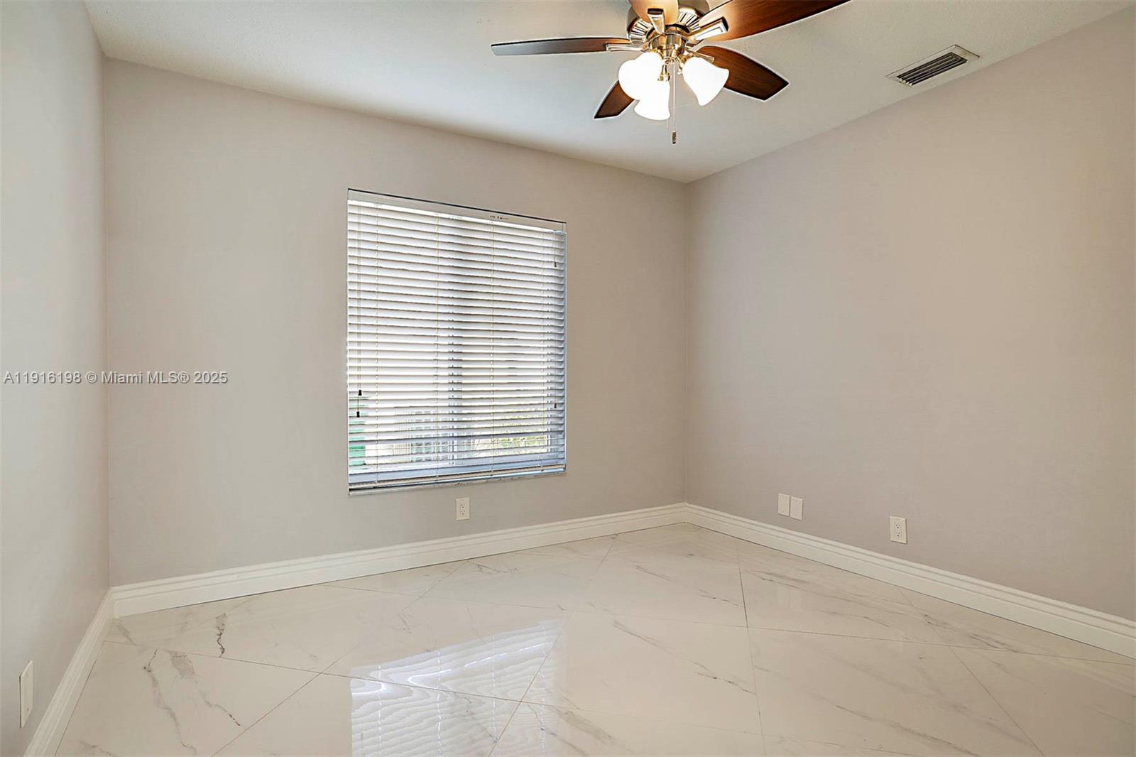10133 Northwest 48th Drive Coral Springs, FL 33076 - Photo 38 of 49 an empty room with a window and a fan