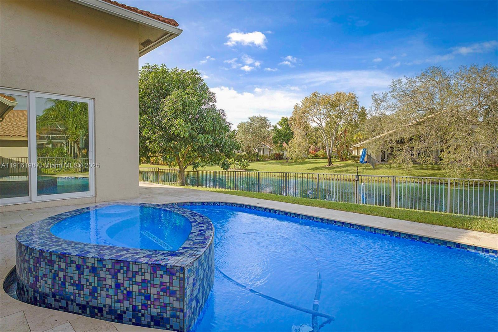 10133 Northwest 48th Drive Coral Springs, FL 33076 - Photo 45 of 49 a view of swimming pool with lake and mountain in the back