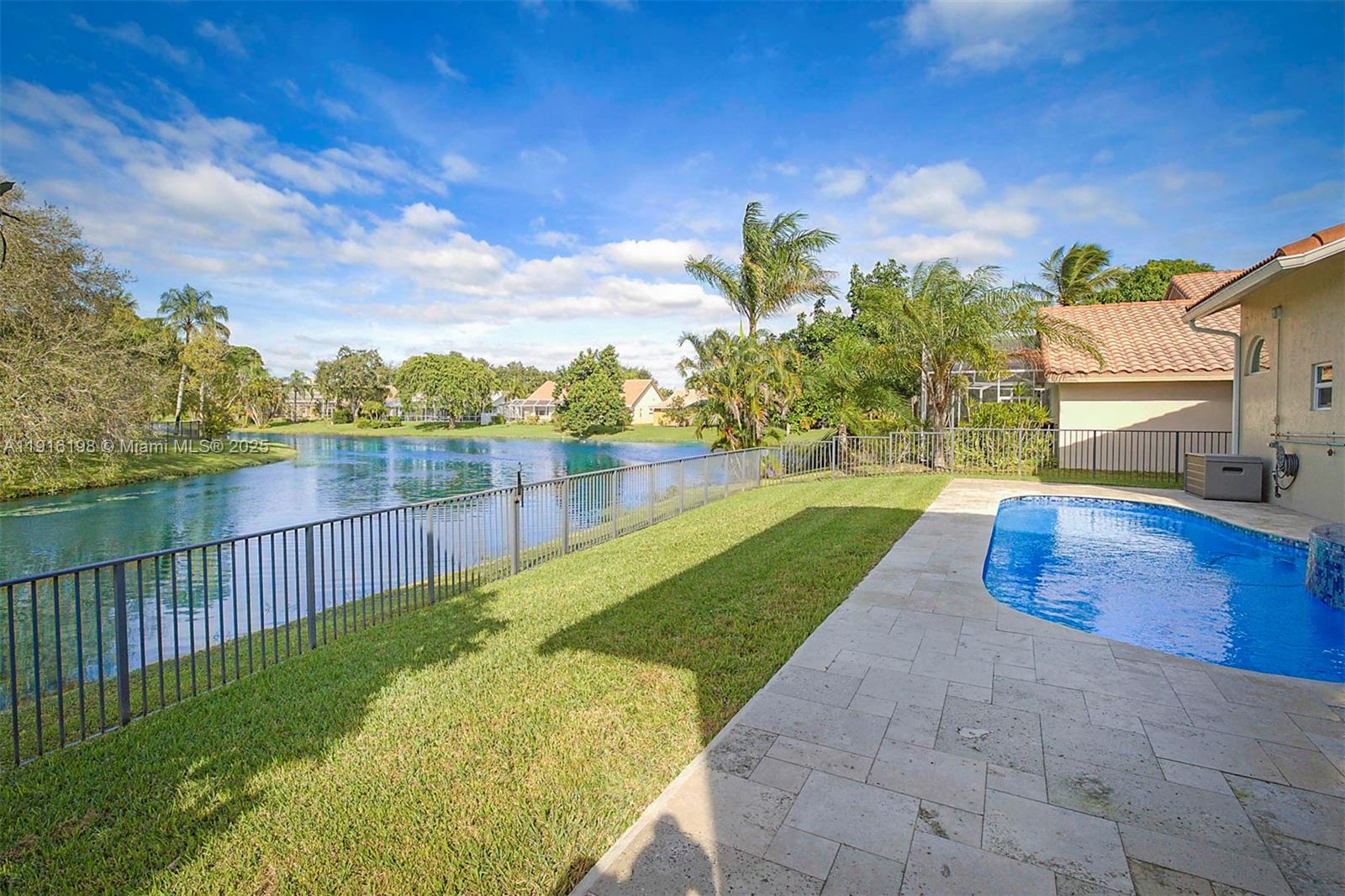 10133 Northwest 48th Drive Coral Springs, FL 33076 - Photo 47 of 49 a view of a swimming pool with a patio