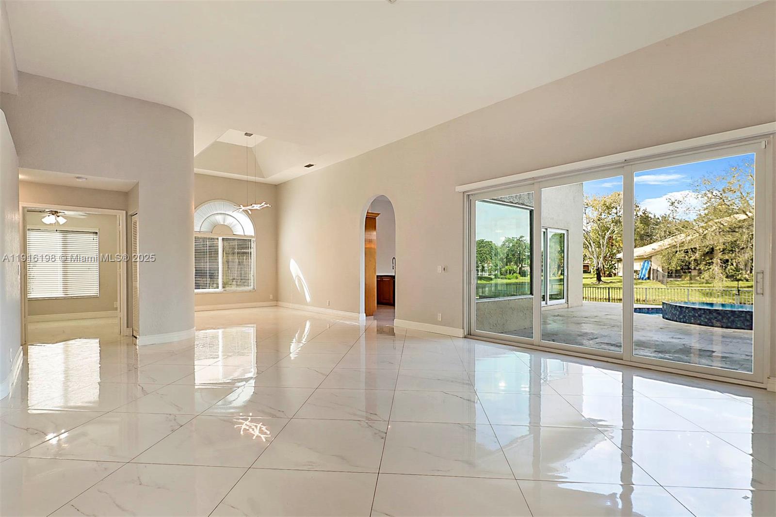 10133 Northwest 48th Drive Coral Springs, FL 33076 - Photo 7 of 49 a view of an entryway with wooden floor and door