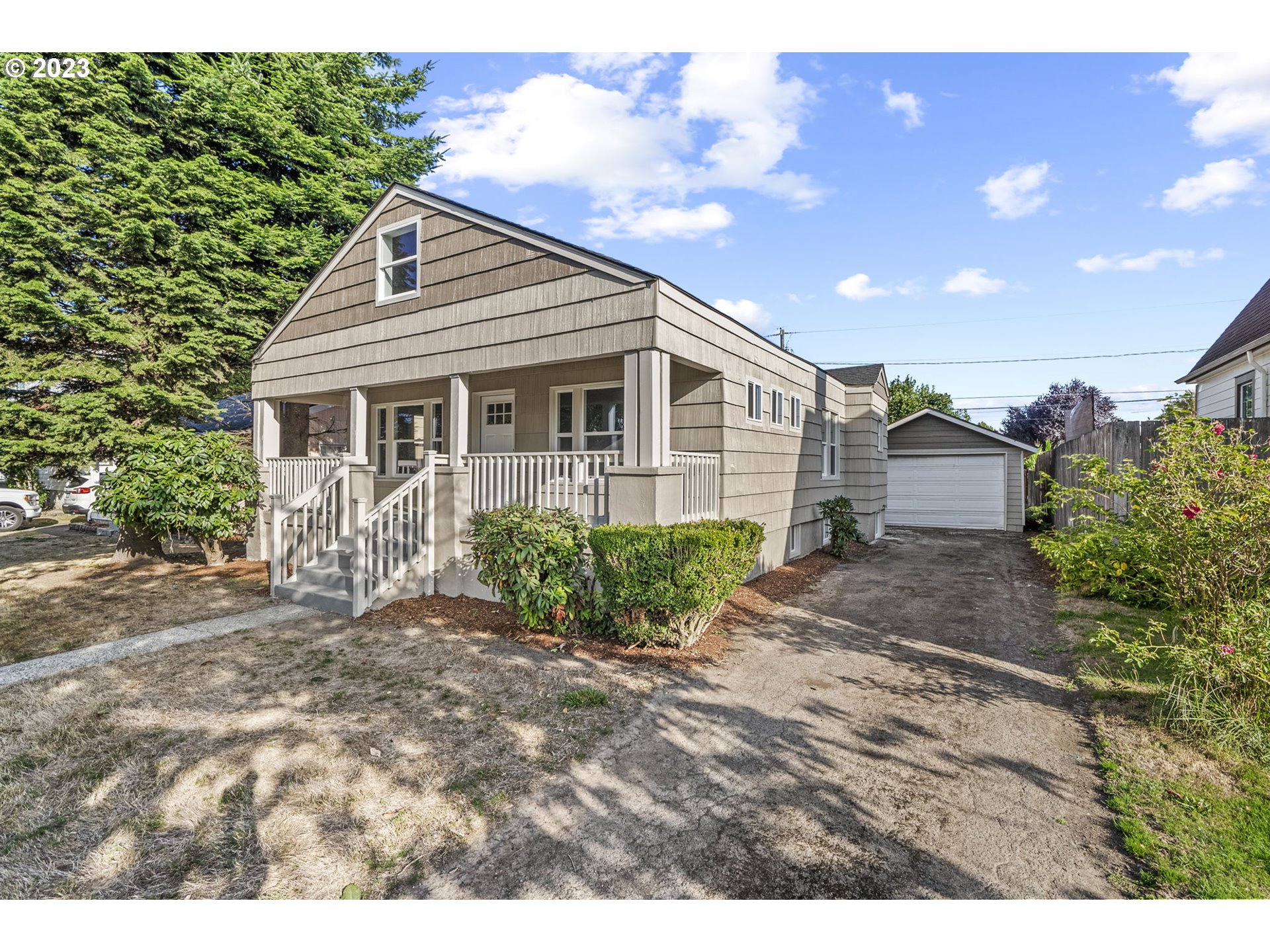 a view of a house with a yard and a garden