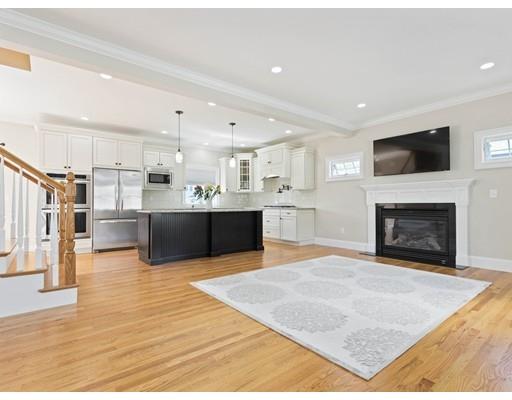 19 Fredette Road Newton, MA 02459 - Photo 2 of 29 a living room with stainless steel appliances kitchen island a fireplace and a television