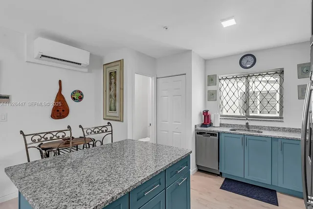 a kitchen with a sink a stove and cabinets