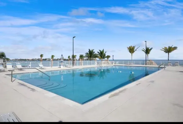 a view of a swimming pool with a yard