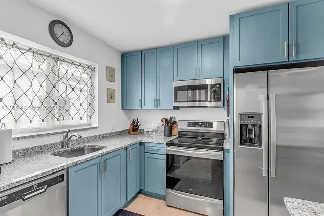 a kitchen with a sink stove and refrigerator