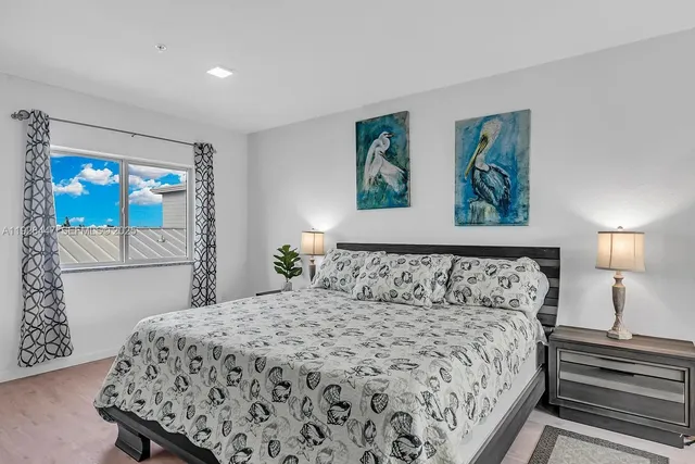 a bedroom with a large bed and a window