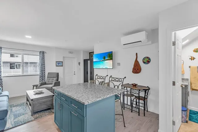 a living room with kitchen island furniture and a window