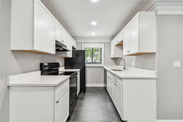 a kitchen with a sink cabinets and window
