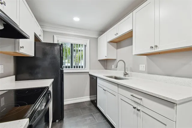 a view of a kitchen sink and a window in the kitchen