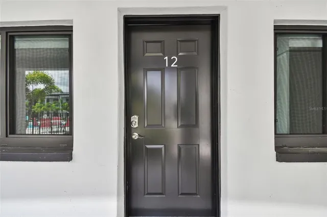 a view of a hallway with a door and a mirror