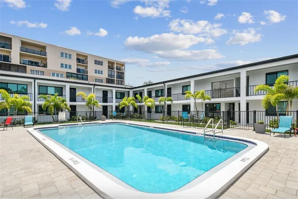a view of swimming pool with outdoor seating