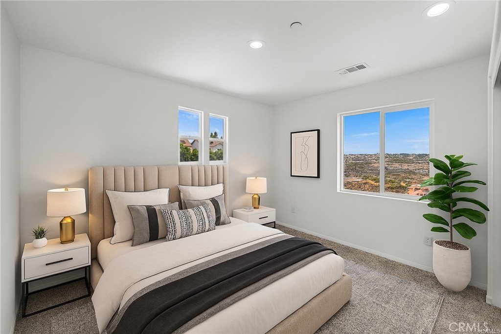 13105 Via Tuscany Riverside, CA 92503 - Photo 13 of 51 a bedroom with bed and a potted plant