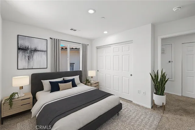 a bedroom with a bed and a potted plant