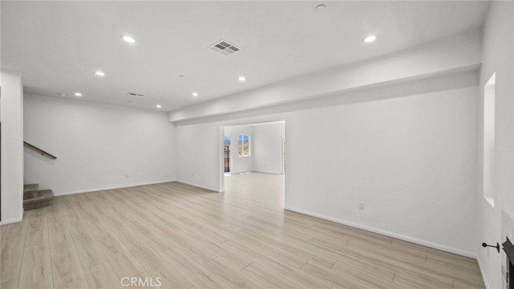 13105 Via Tuscany Riverside, CA 92503 - Photo 18 of 51 an empty room with wooden floor and windows