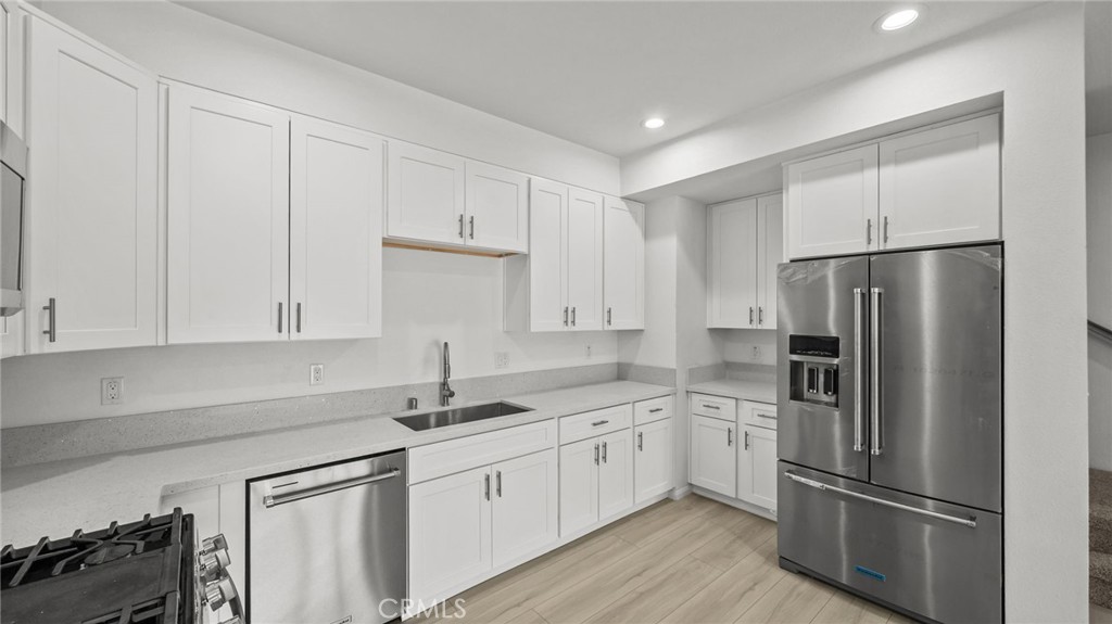 13105 Via Tuscany Riverside, CA 92503 - Photo 22 of 51 a kitchen with a refrigerator sink and cabinets
