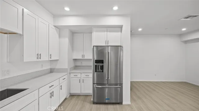 a kitchen with cabinets and stainless steel appliances
