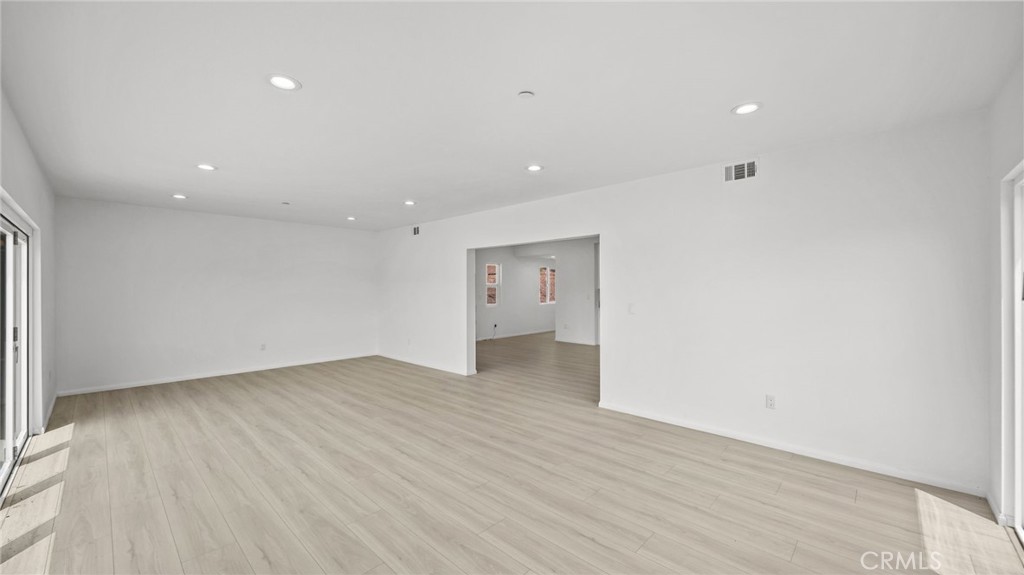 13105 Via Tuscany Riverside, CA 92503 - Photo 27 of 51 an empty room with wooden floor and windows