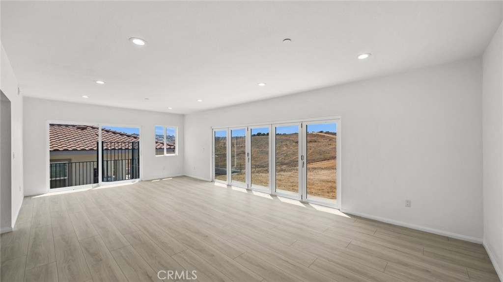 13105 Via Tuscany Riverside, CA 92503 - Photo 28 of 51 an empty room with wooden floor and windows