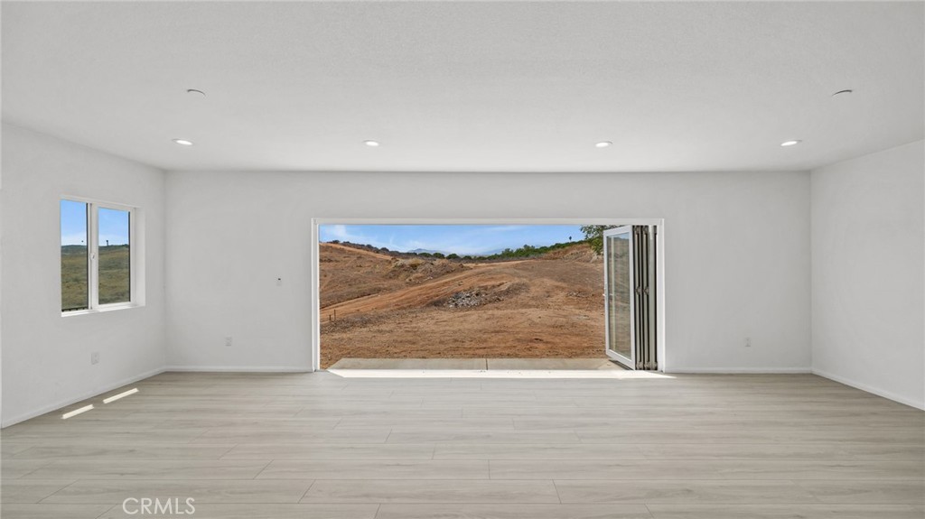 13105 Via Tuscany Riverside, CA 92503 - Photo 30 of 51 an empty room with wooden floor and a window