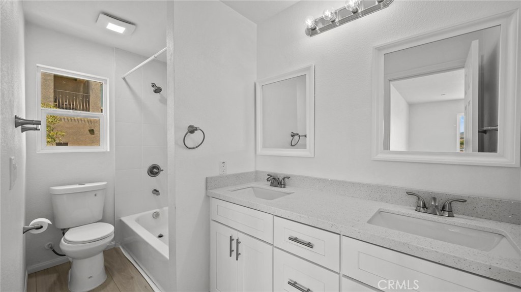 13105 Via Tuscany Riverside, CA 92503 - Photo 35 of 51 a bathroom with a granite countertop toilet sink and a mirror