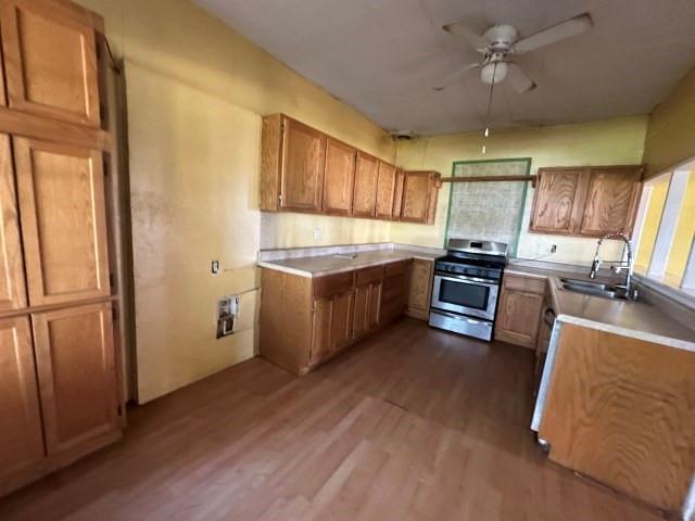 202 Mill Street Valley View, TX 76272 - Photo 11 of 22 a kitchen with stainless steel appliances granite countertop a refrigerator a sink a stove a dining table and chairs with wooden floor