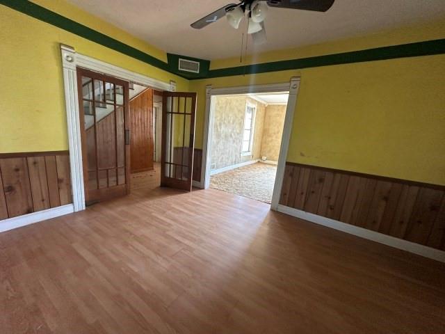 202 Mill Street Valley View, TX 76272 - Photo 9 of 22 an empty room with wooden floor and windows