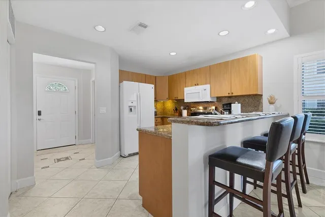 a bedroom with a bed and a flat tv screen on dresser