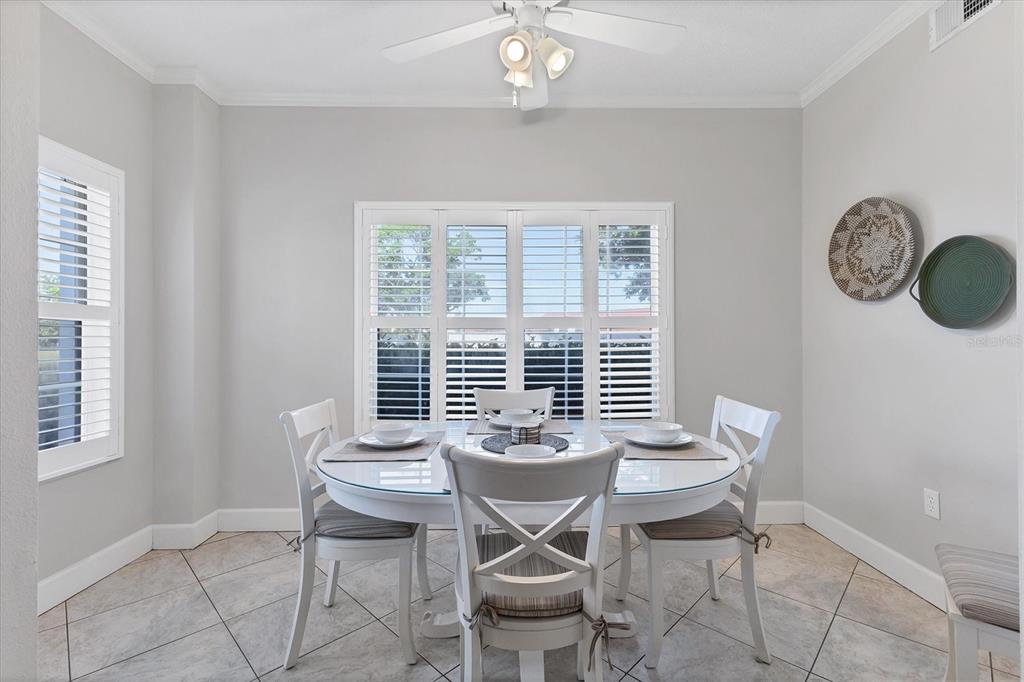 3605 54th Drive West, Unit 104 Bradenton, FL 34210 - Photo 17 of 65 a view of a dining room with furniture and chandelier