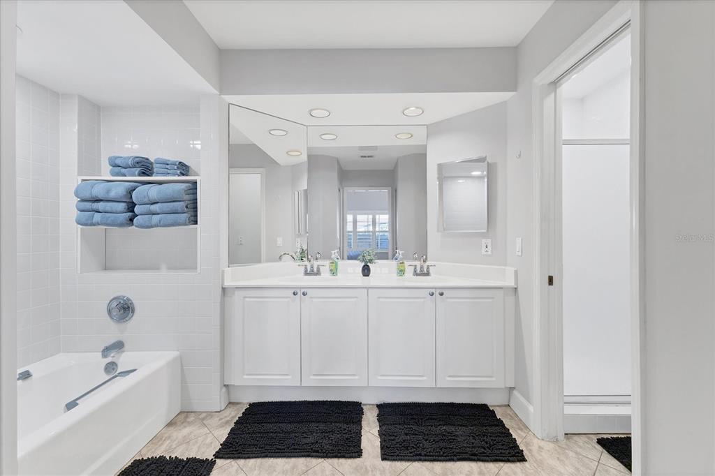 3605 54th Drive West, Unit 104 Bradenton, FL 34210 - Photo 20 of 65 a bathroom with a bathtub a sink a toilet and a mirror