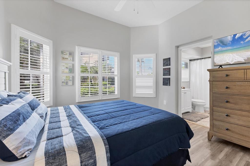 3605 54th Drive West, Unit 104 Bradenton, FL 34210 - Photo 23 of 65 a bedroom with a bed and a dresser