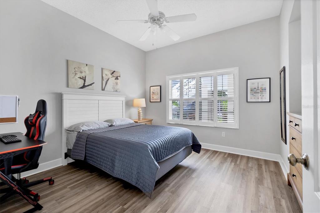 3605 54th Drive West, Unit 104 Bradenton, FL 34210 - Photo 25 of 65 a bedroom with a bed and a window