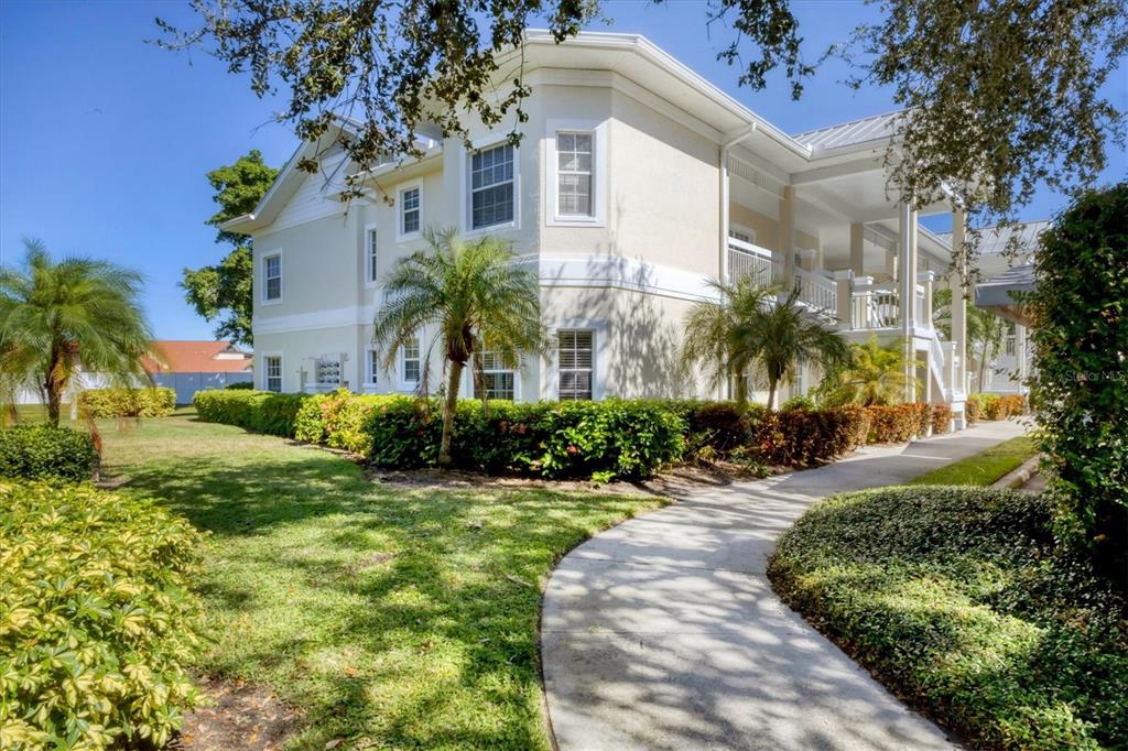 3605 54th Drive West, Unit 104 Bradenton, FL 34210 - Photo 29 of 65 a front view of a house with a yard