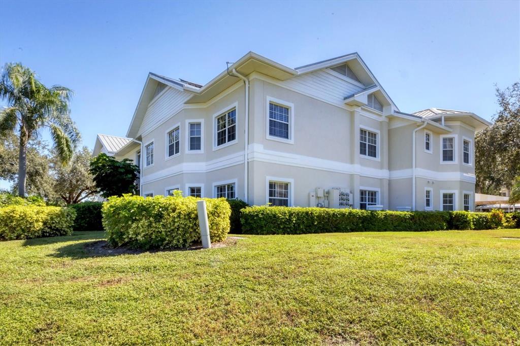 3605 54th Drive West, Unit 104 Bradenton, FL 34210 - Photo 30 of 65 a front view of a house with a yard