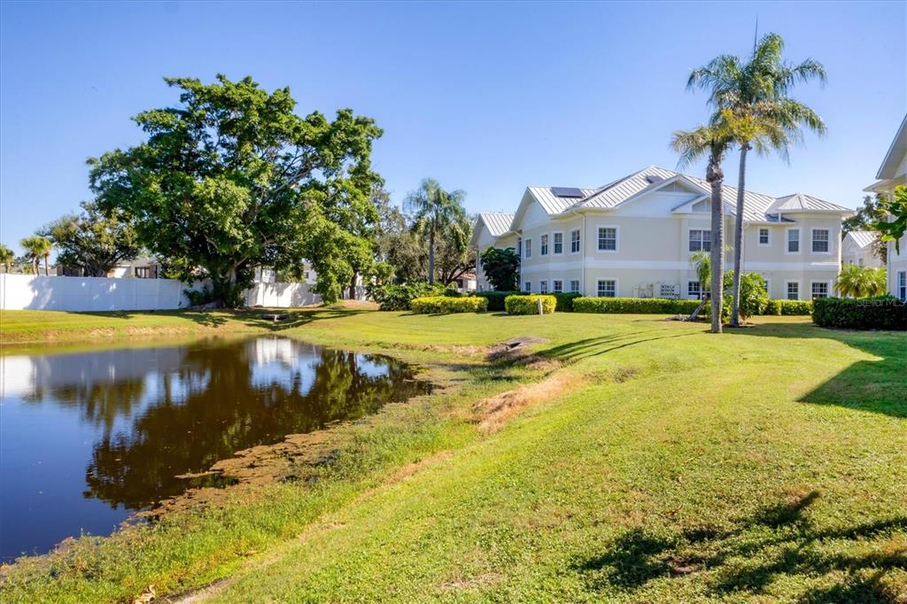 3605 54th Drive West, Unit 104 Bradenton, FL 34210 - Photo 31 of 65 a view of a house with swimming pool and a yard
