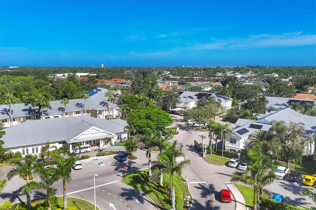 3605 54th Drive West, Unit 104 Bradenton, FL 34210 - Photo 35 of 65 an aerial view of residential houses with outdoor space and ocean view