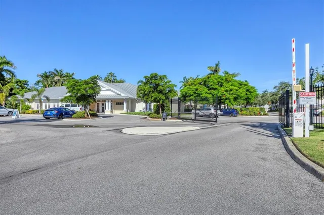 a view of a patio with couches table and chairs under an umbrella