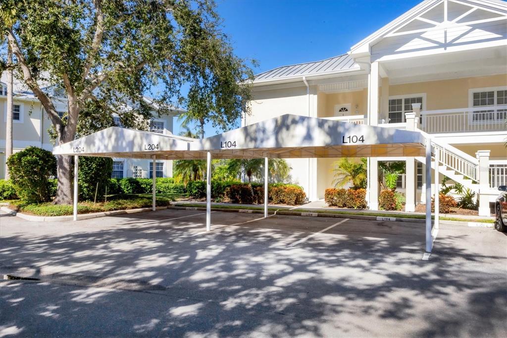 3605 54th Drive West, Unit 104 Bradenton, FL 34210 - Photo 4 of 65 a view of a brick building with a large windows