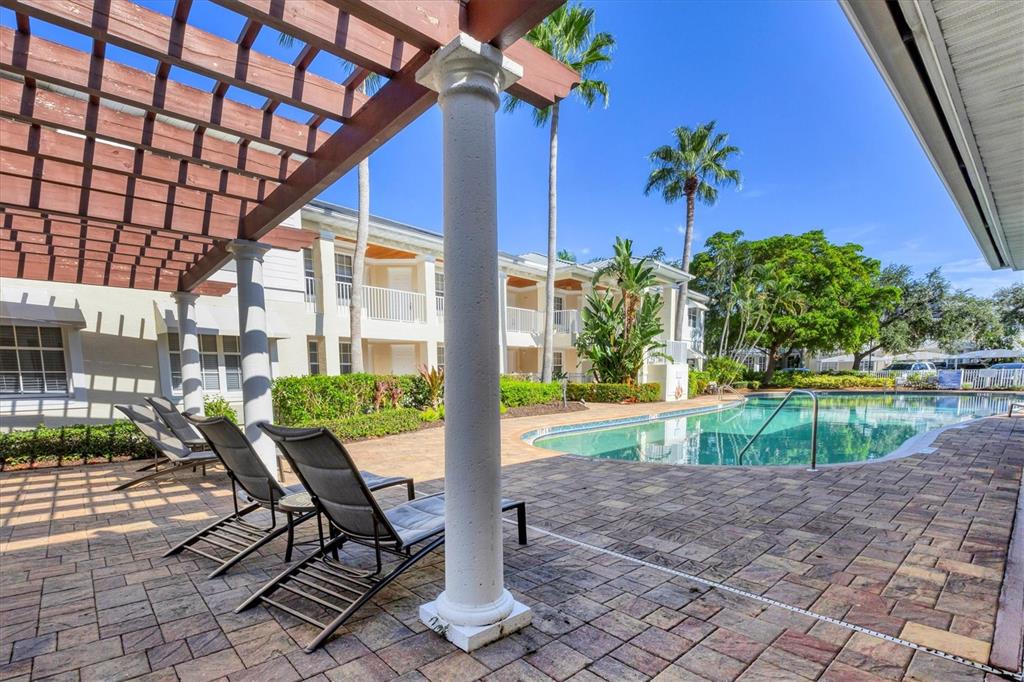 3605 54th Drive West, Unit 104 Bradenton, FL 34210 - Photo 42 of 65 a view of a swimming pool with a patio