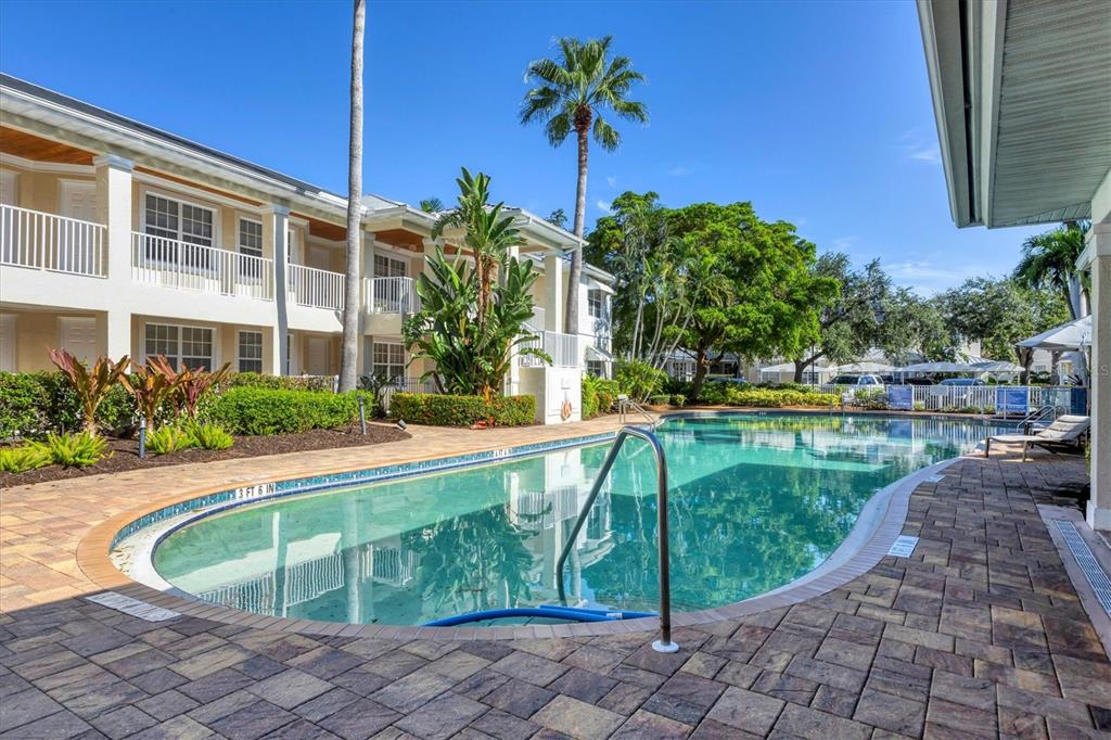 3605 54th Drive West, Unit 104 Bradenton, FL 34210 - Photo 44 of 65 a view of a swimming pool with a patio