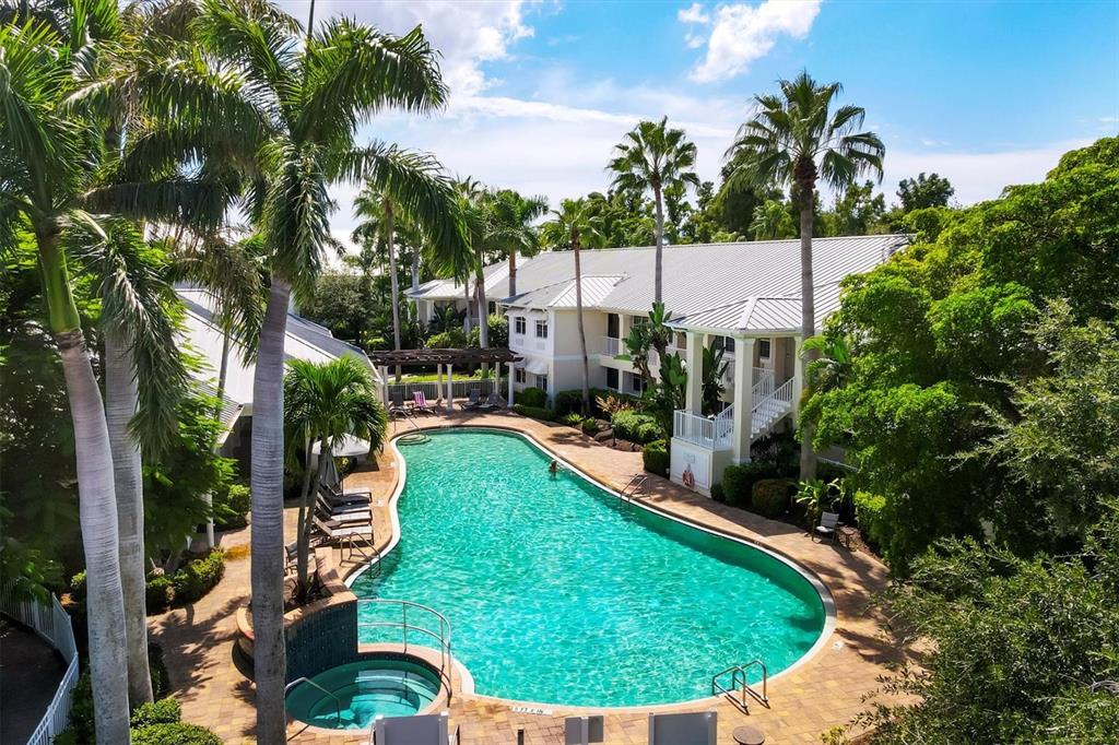 3605 54th Drive West, Unit 104 Bradenton, FL 34210 - Photo 51 of 65 a view of a swimming pool with a patio