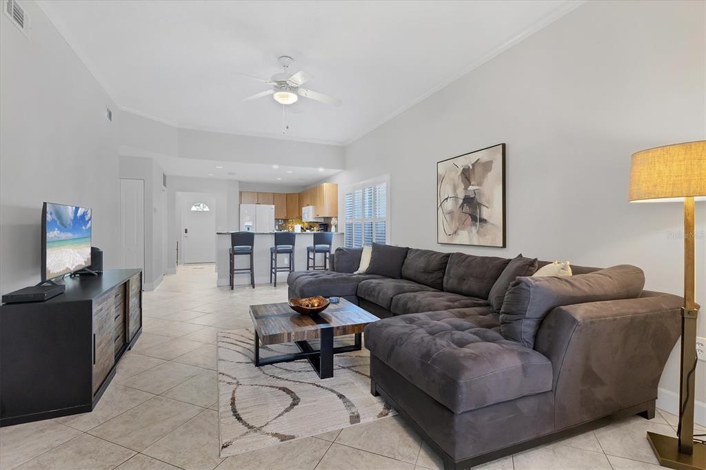 3605 54th Drive West, Unit 104 Bradenton, FL 34210 - Photo 9 of 65 a living room with furniture and a flat screen tv