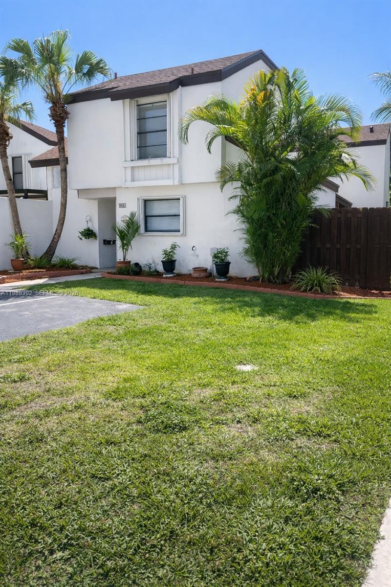 441 Northwest 98th Court, Unit 441 Miami, FL 33172 - Photo 1 of 18 a front view of a house with garden