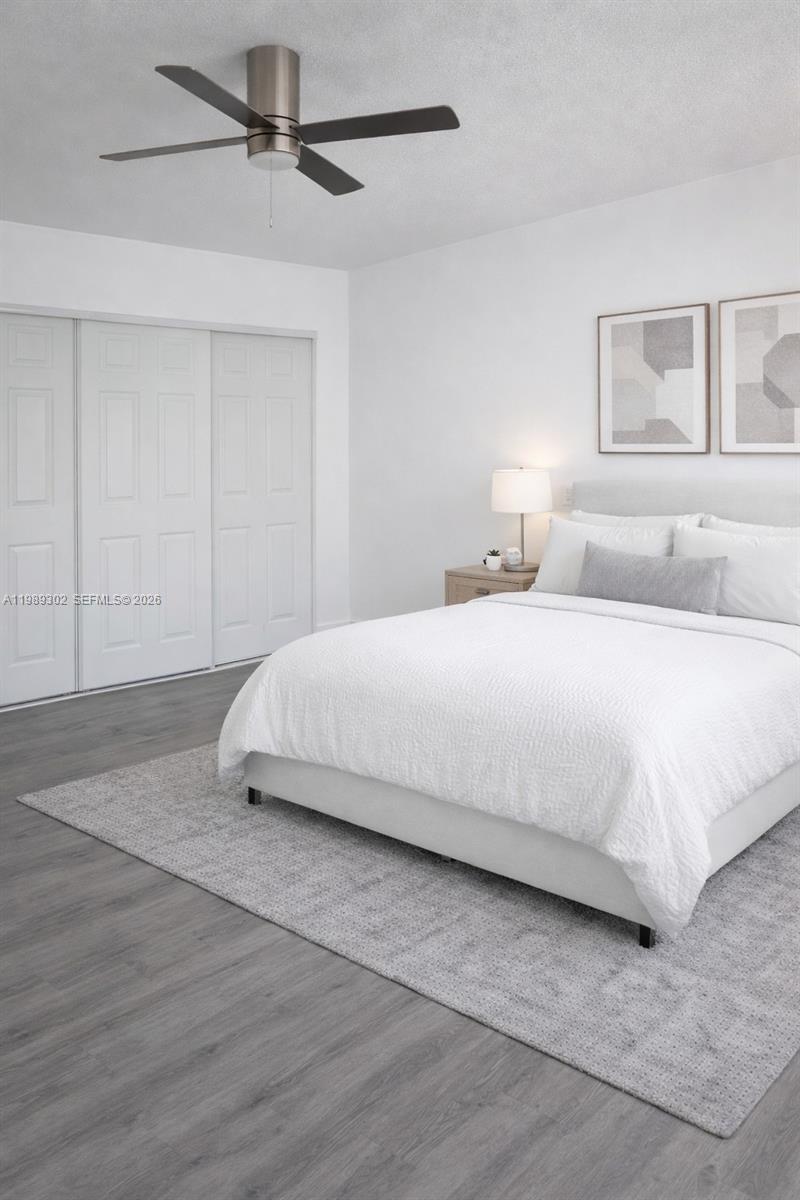 441 Northwest 98th Court, Unit 441 Miami, FL 33172 - Photo 11 of 18 a bedroom with a bed and wooden floor