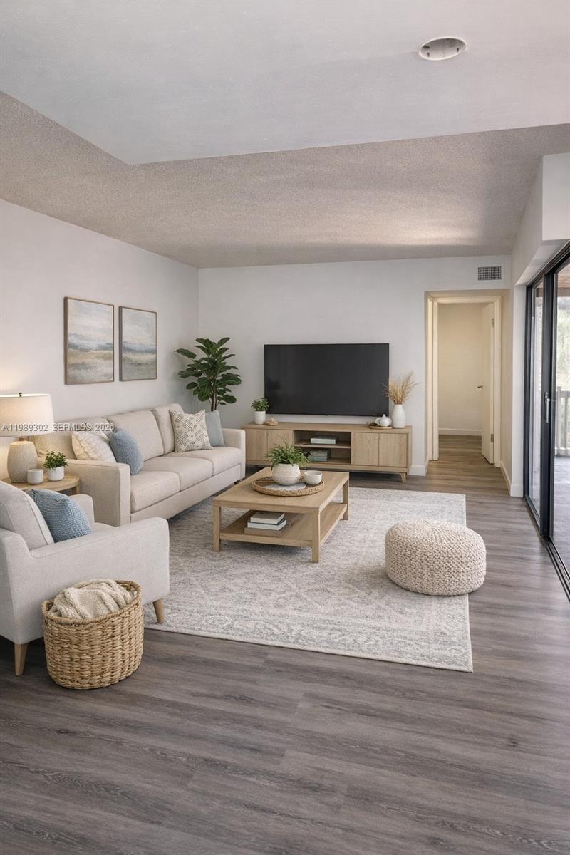 441 Northwest 98th Court, Unit 441 Miami, FL 33172 - Photo 4 of 18 a living room with furniture and a flat screen tv