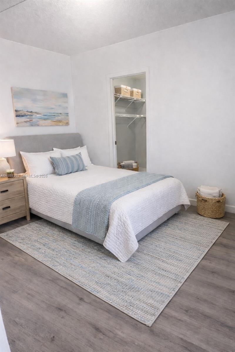 441 Northwest 98th Court, Unit 441 Miami, FL 33172 - Photo 7 of 18 a bedroom with a bed and a night stand