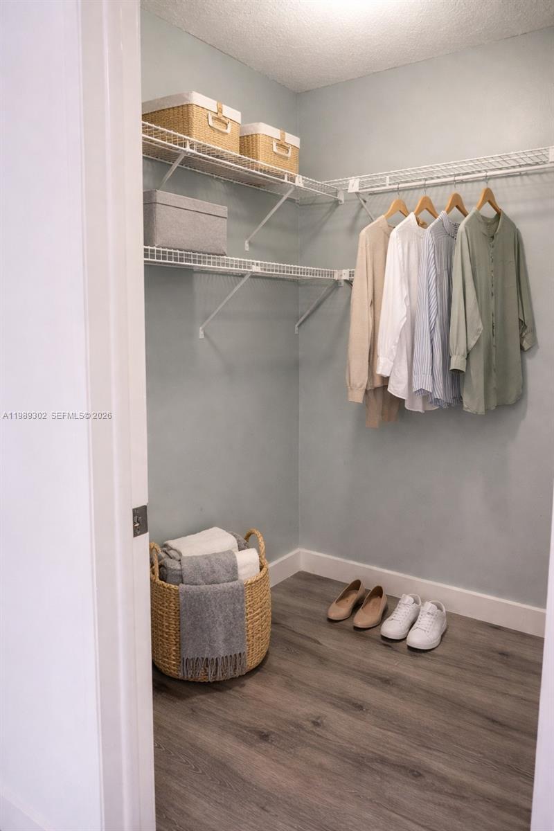 441 Northwest 98th Court, Unit 441 Miami, FL 33172 - Photo 8 of 18 a room with a wooden floor and a curtain