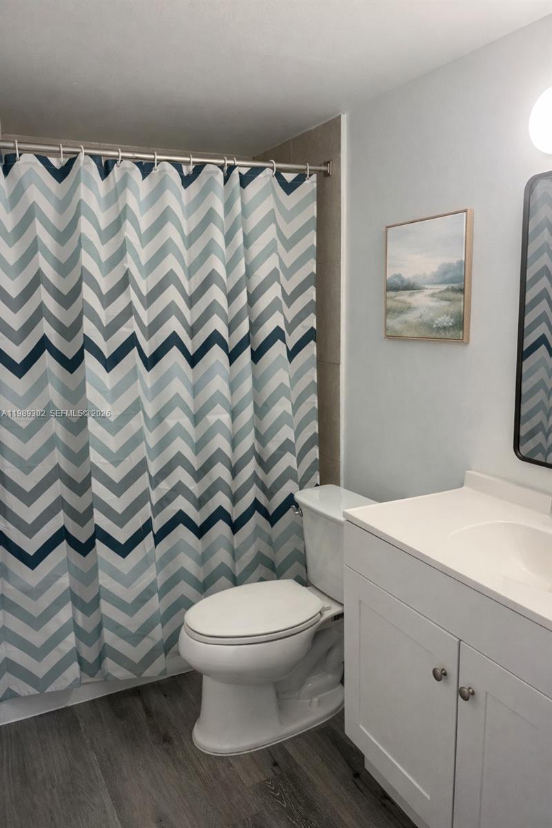 441 Northwest 98th Court, Unit 441 Miami, FL 33172 - Photo 9 of 18 a bathroom with a toilet and a shower curtain