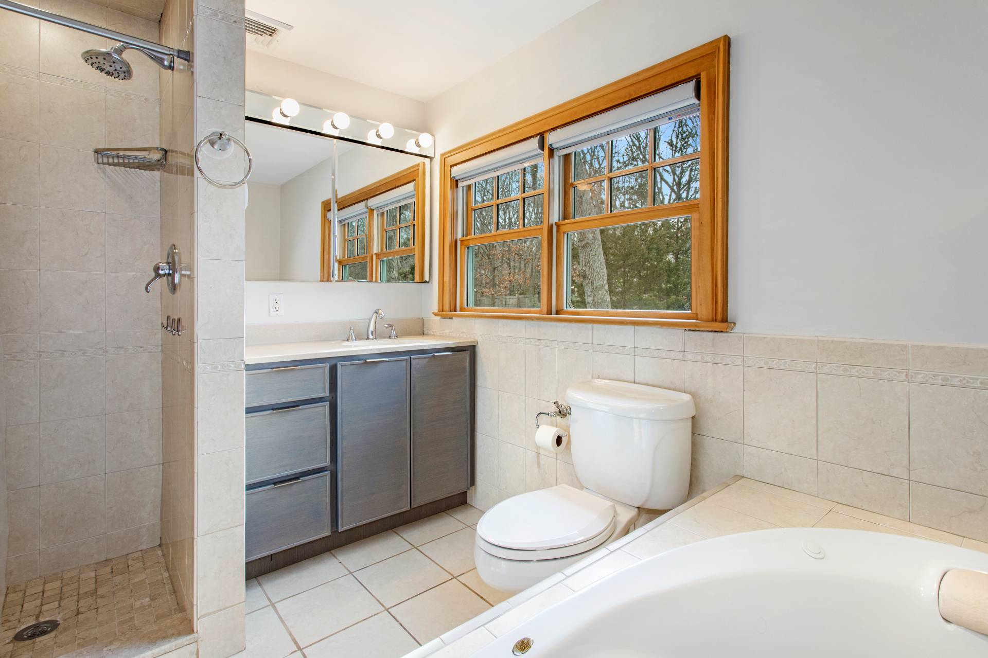 3752 Noyack Road Sag Harbor, NY 11963 - Photo 20 of 28 a bathroom with a sink a toilet and shower