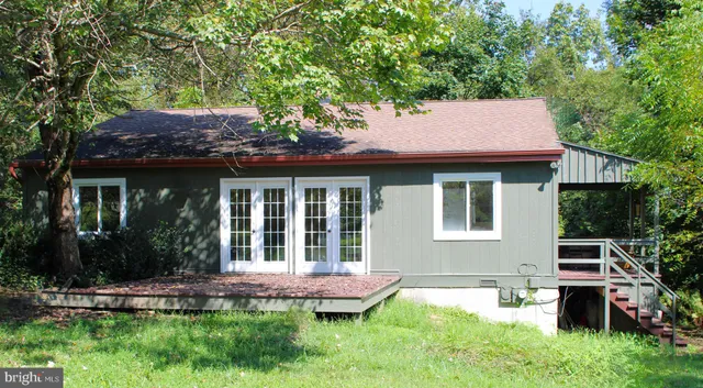 a backyard of a house with yard and outdoor seating